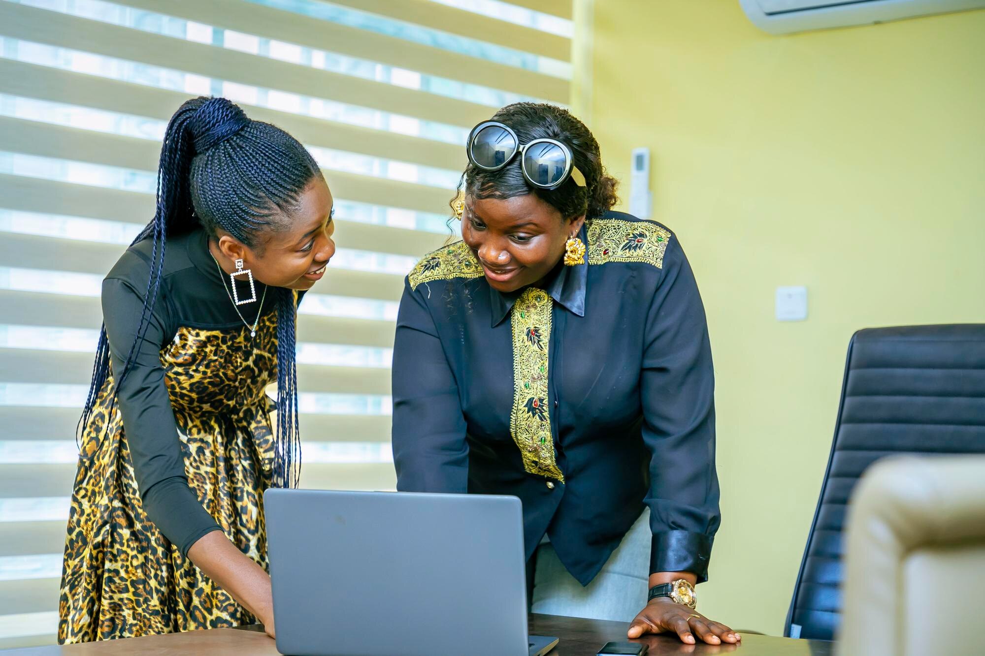 Two colleagues planning at a laptop in an office
